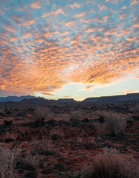 Spotted clouds over a desert landscape at sunset