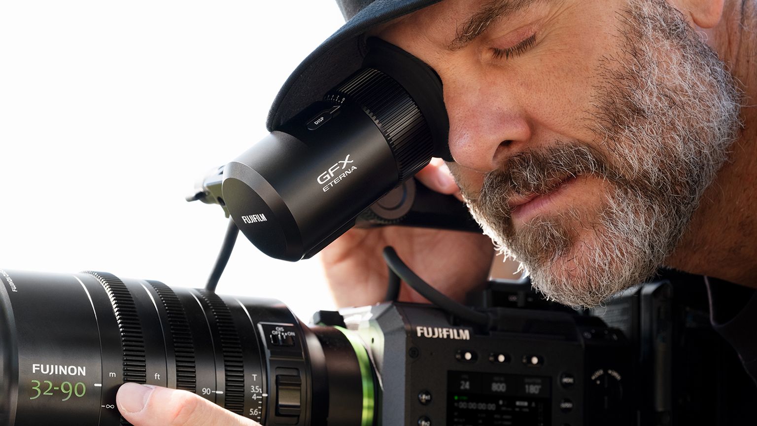 camera operator using the vf-gfxc2 viewfinder on a fujifilm gfx eterna 55